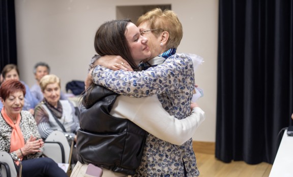 Abrazo entre una alumna y una participante de "Dame tu mano"