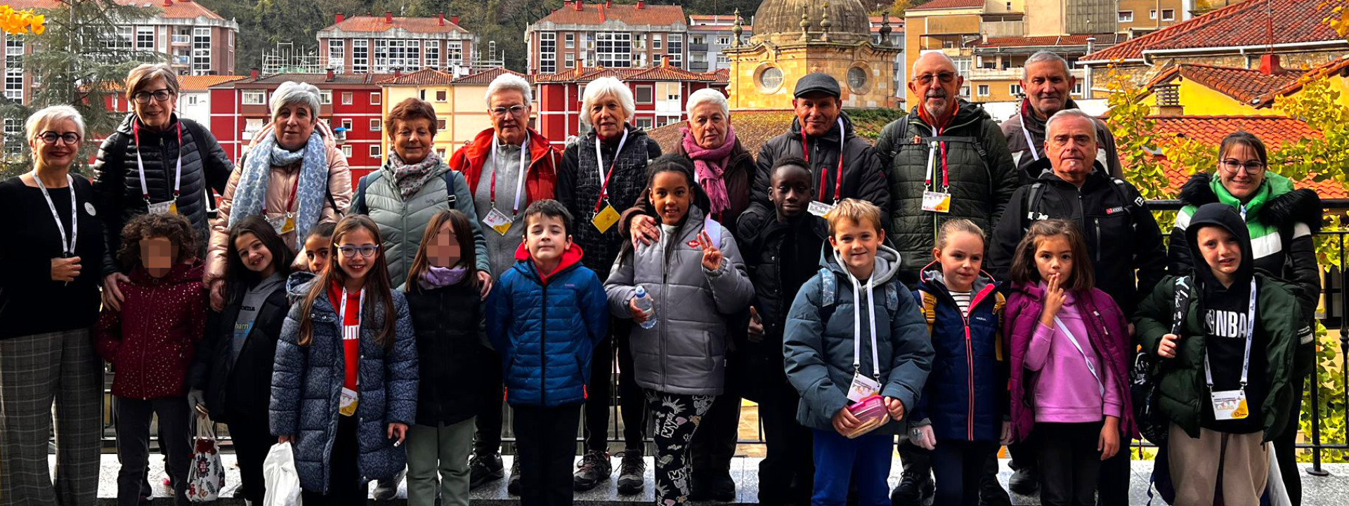 IX. Haurren Kontseiluko kideak, adineko pertsonak eta udaleko teknikariak liburutegiko sarreran | El IX Consejo de la Infancia con personas mayores y técnicos/as del ayuntamiento en la entrada de la biblioteca